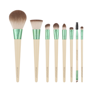 Makeup brush set with green handles and beige bristles, assorted sizes