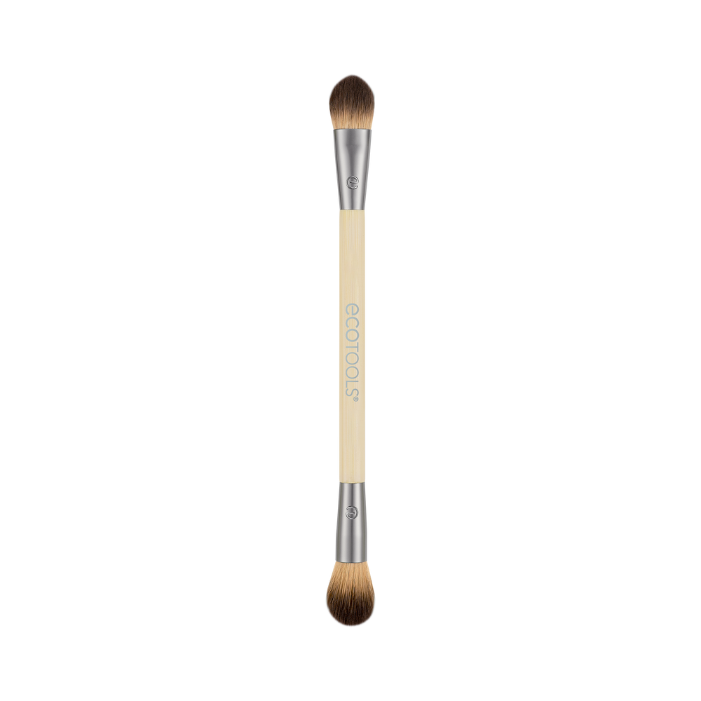 Dual-ended eye makeup brush with cream handle and brown bristles, two tapered tips.