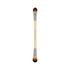Dual-ended eye makeup brush with cream handle and brown bristles, two tapered tips.