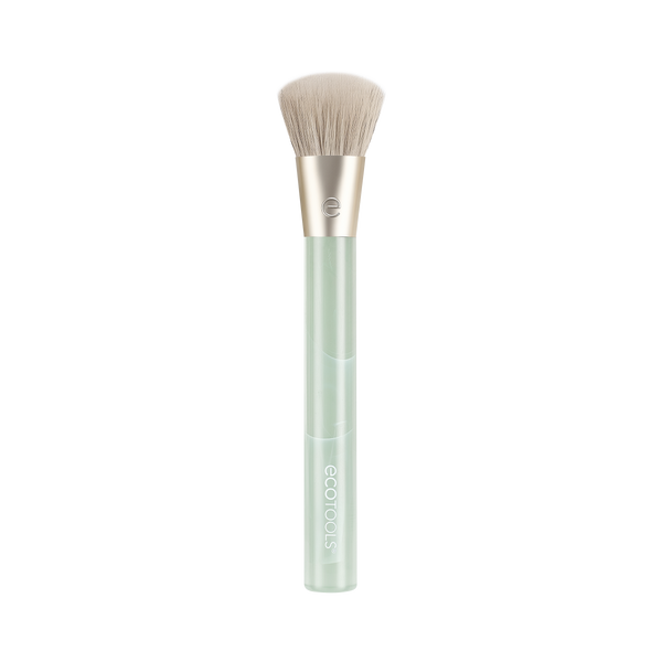 Cream blush makeup brush with soft beige bristles and light green translucent handle
