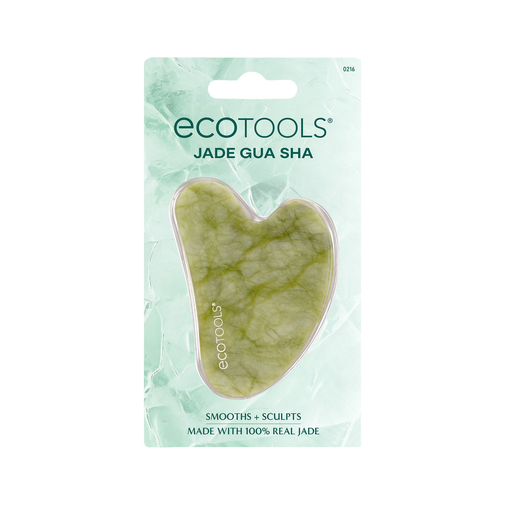 Heart-shaped jade gua sha tool, light green stone with swirled texture