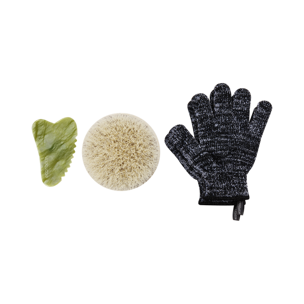 Exfoliating tool set: green gua sha, beige body brush, dark scrub gloves