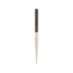 Slick back brush top view with small rounded black bristle tips on cream base