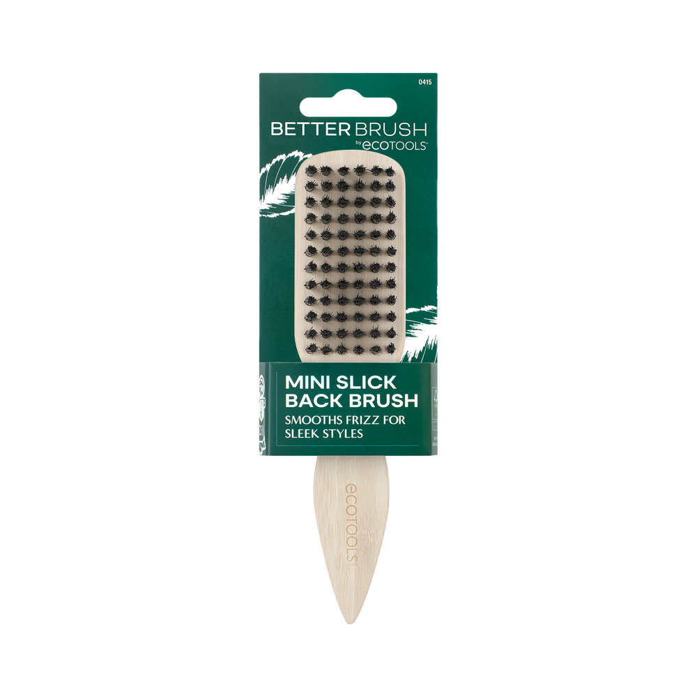 Mini slick back brush with black bristles on beige handle