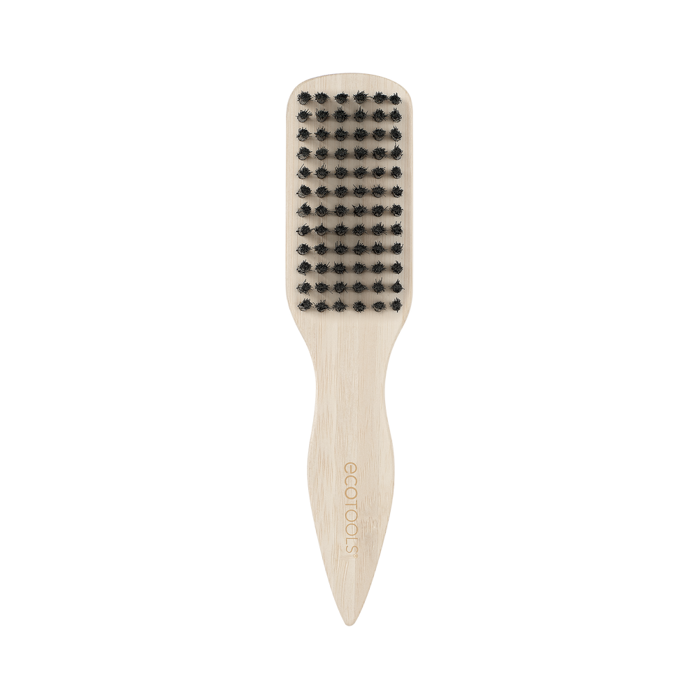 Mini slick back brush with black bristles on beige handle