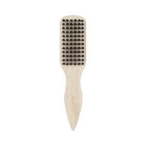 Mini slick back brush with black bristles on beige handle