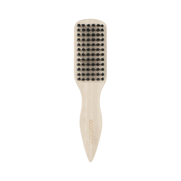Mini slick back brush with black bristles on beige handle