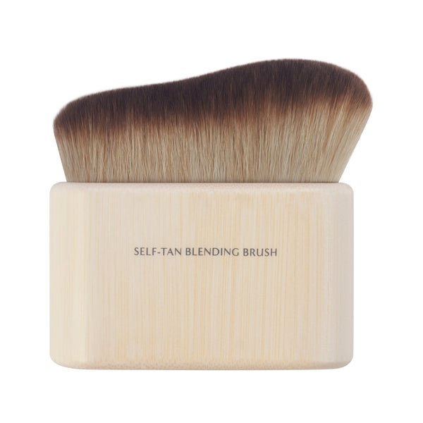 Self-tan blending brush with dense angled bristles and light bamboo handle