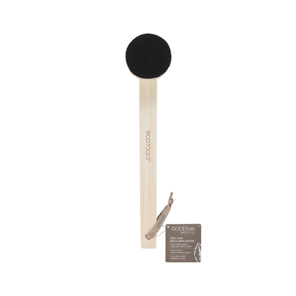 Wood self-tan applicator with round black brush head and included product packet
