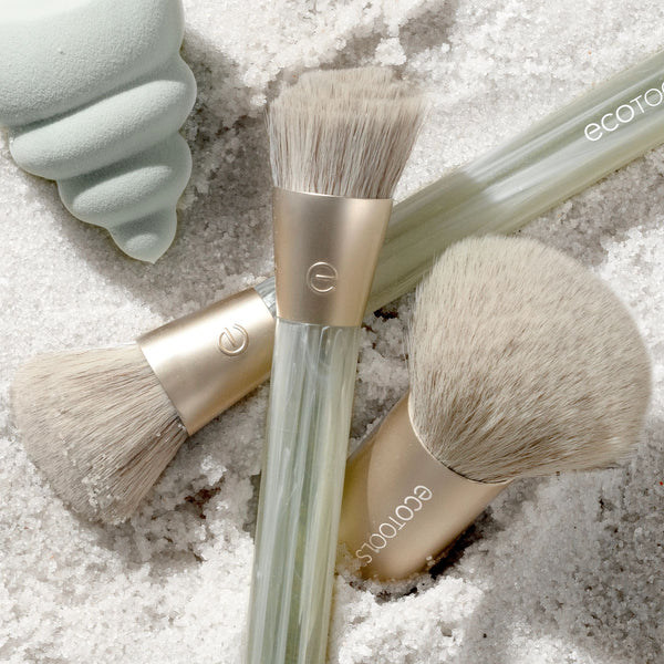 Face brush set with beige bristles and translucent clear handles, metallic caps