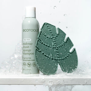 Green silicone makeup brush cleansing pad with soap bubbles and cleaning texture