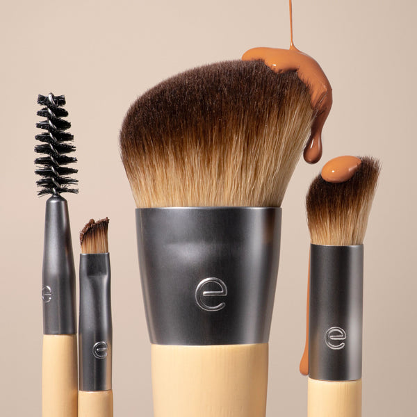 Makeup brush trio close-up showing a large face brush and two smaller brushes