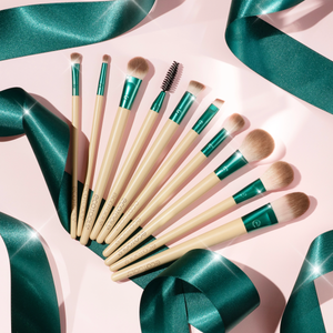 10-piece makeup brush set arranged on a flat surface with teal ferrules and cream handles