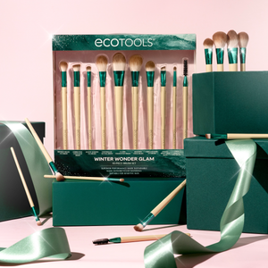 Makeup brush gift set in teal box with ribbon, brushes and accessories displayed