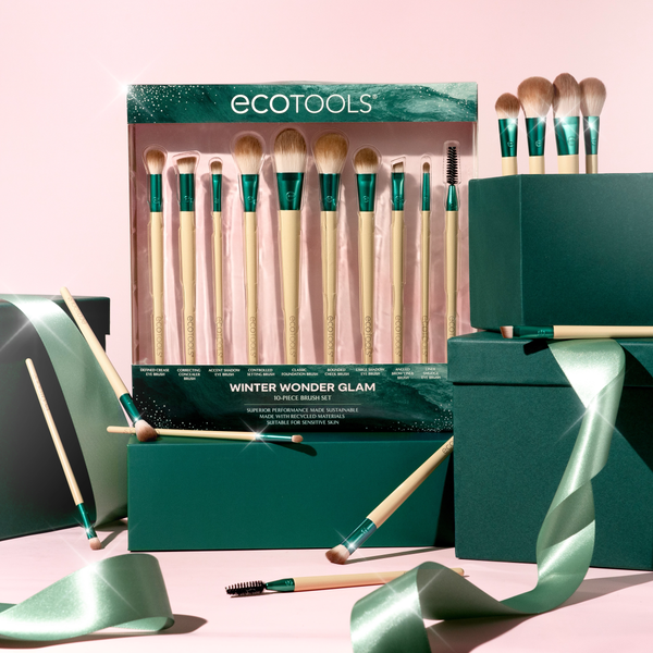 Makeup brush gift set in teal box with ribbon, brushes and accessories displayed