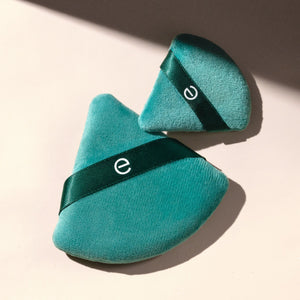 Teal triangular powder puffs with dark green band and small e logo
