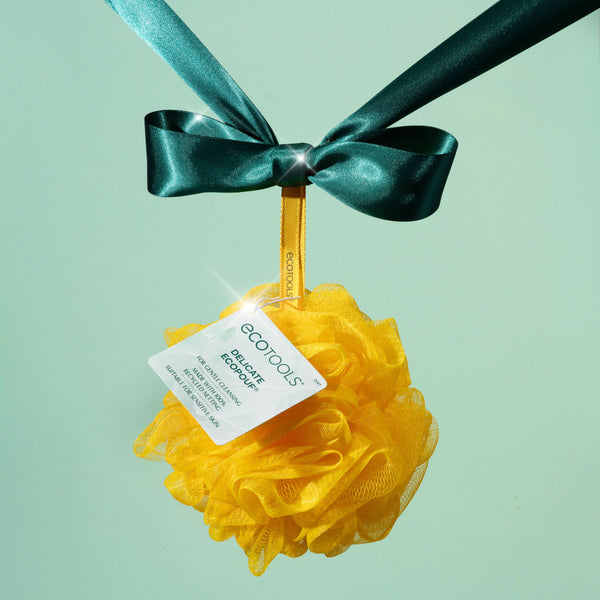 Yellow delicate EcoPouf exfoliating sponge with satin bow and tag