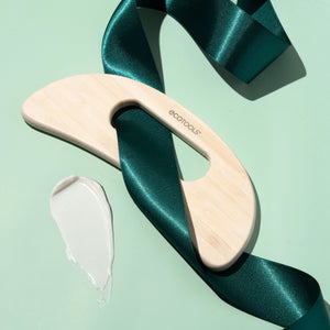 Light wood bamboo body massager with ecotools logo on teal ribbon