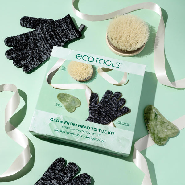 Ecotools glow kit box with black shower gloves, brush, and gua sha tools