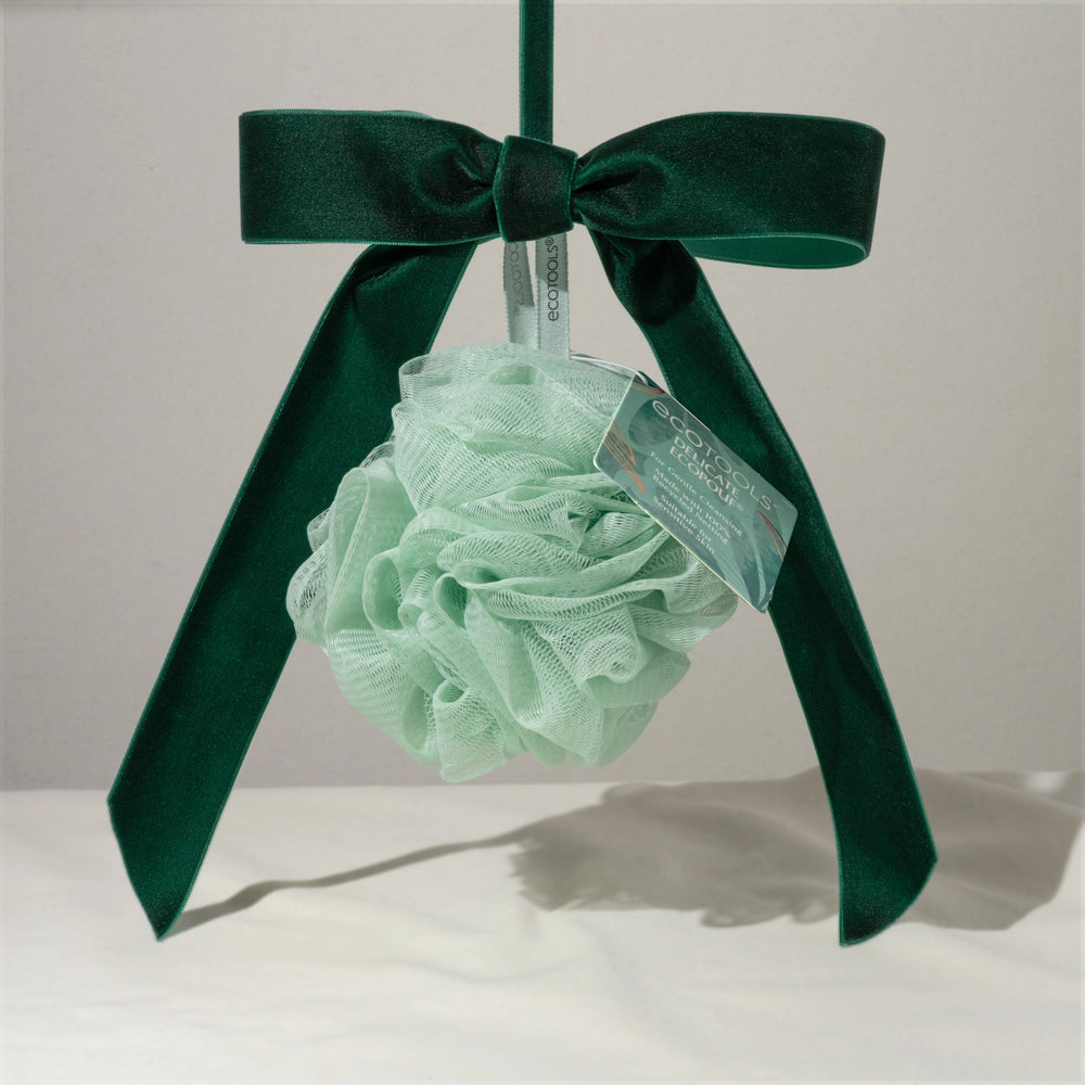 Delicate pouf: mint green mesh scrub ball with hanging loop and printed label