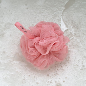 Delicate EcoPouf pink mesh cleansing puff with layered ruffled texture