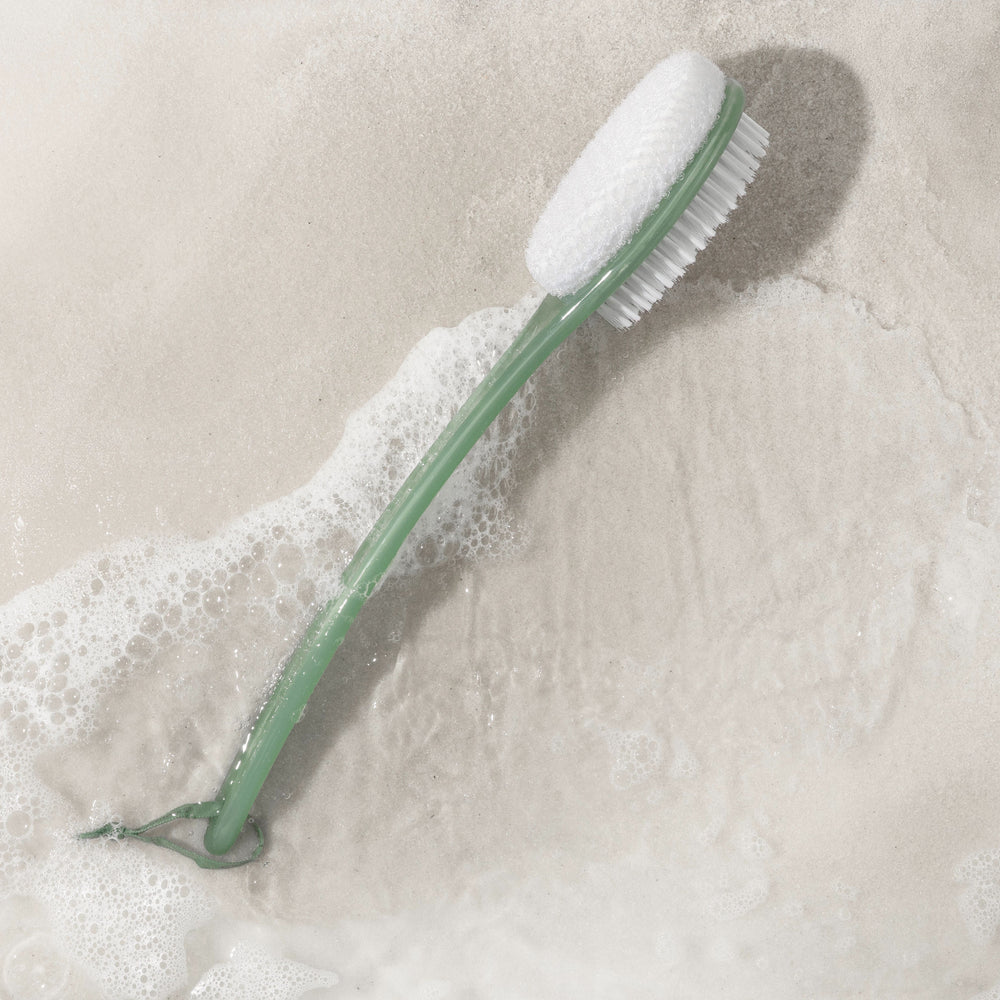 Green handle bath bristle brush with white soft brush head and curved end