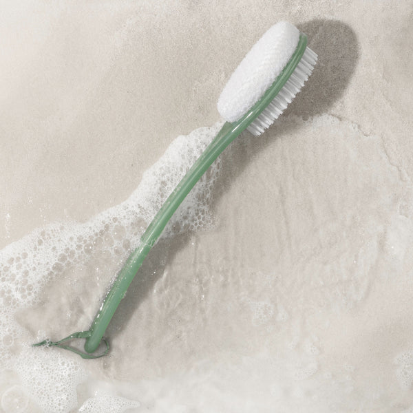 Green handle bath bristle brush with white soft brush head and curved end