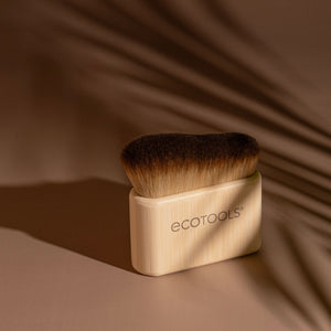 Self-tan blending brush with dark bristles and light bamboo handle, ECOTOOLS logo