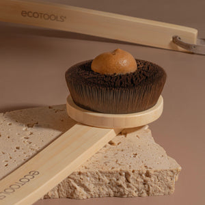 Round self-tan brush applicator loaded with tan product from a compact