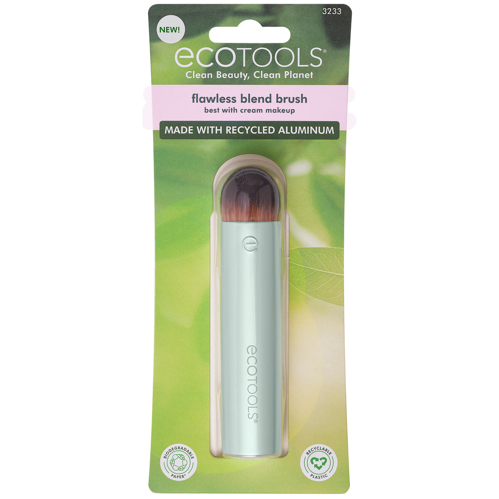Domed blending makeup brush with dense brown bristles on a light mint tube handle