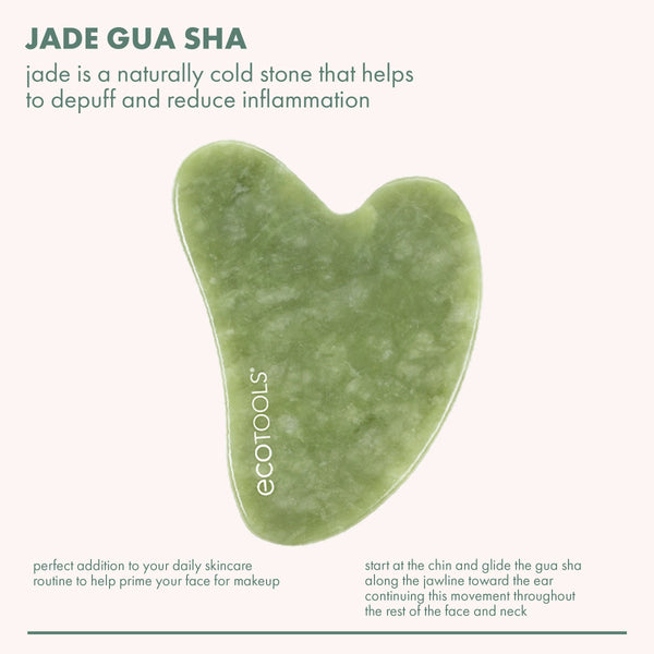Green heart-shaped jade gua sha stone on a card, skincare massage tool
