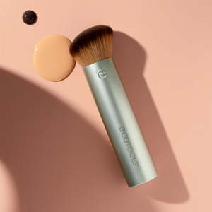 Flawless coverage makeup brush with angled bristles and light gray cylindrical handle