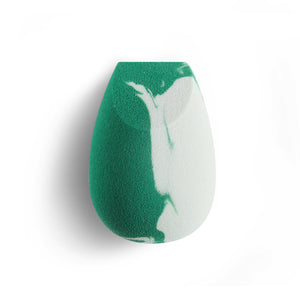 Teardrop facial blending sponge with green and white swirled foam surface.