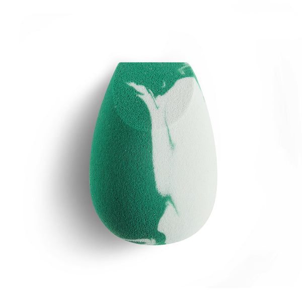 Teardrop facial blending sponge with green and white swirled foam surface.