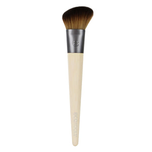 Skin perfecting makeup brush with dark dome-shaped bristles and bamboo handle