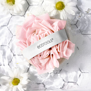 Pink loofah cleansing pad with gray ecotools strap and mesh scrub surface.